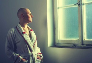 A Bald Woman Looking Out A Window | Illinois Taxotere Hair Loss Lawsuit