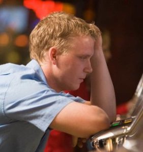 Man looking at a slot machine | New Jersey Abilify Lawsuit