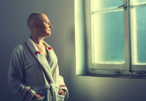 Bald woman looking out a window | Virginia Taxotere Hair Loss Lawsuit