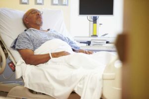 Man in a hospital bed | Washington Metal Hip Replacement Lawsuit