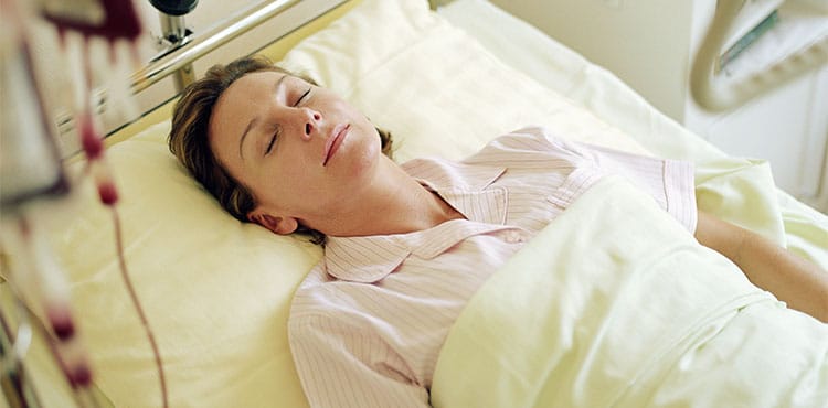 Woman in Hospital Bed | Xarelto Side Effects