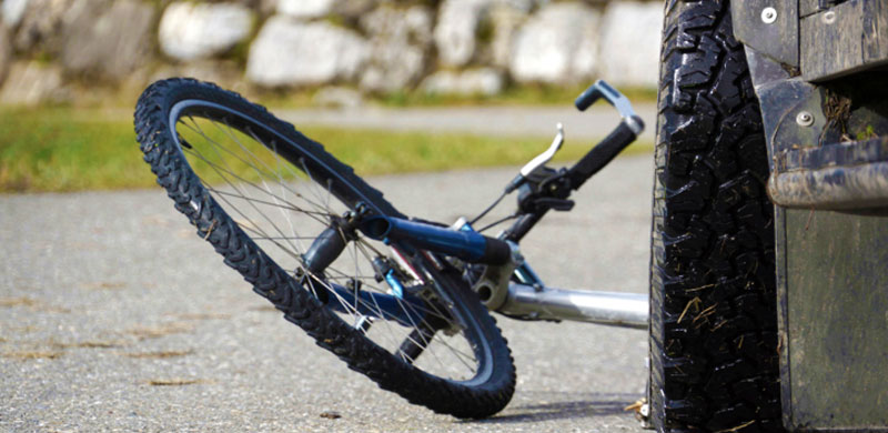 Damaged bike by a car wheel | Bicycle Injury Attorney