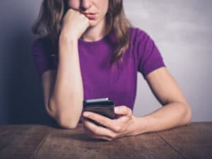 Woman Holding Cellphone | Telemarketer Robocall Lawsuit