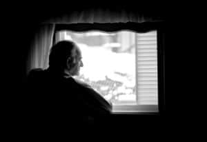 Man Looking Out Window | Georgia Metal Hip Replacement Lawsuit